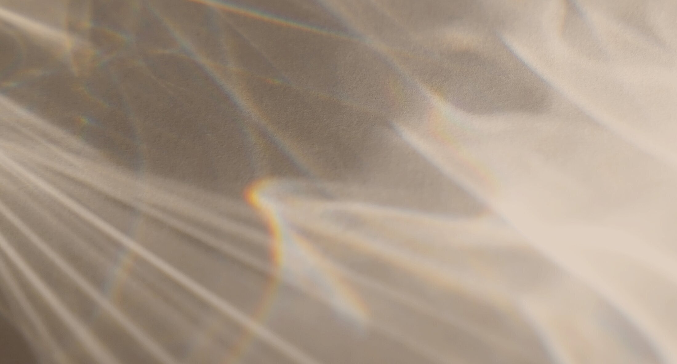 Abstract light patterns on a textured surface.