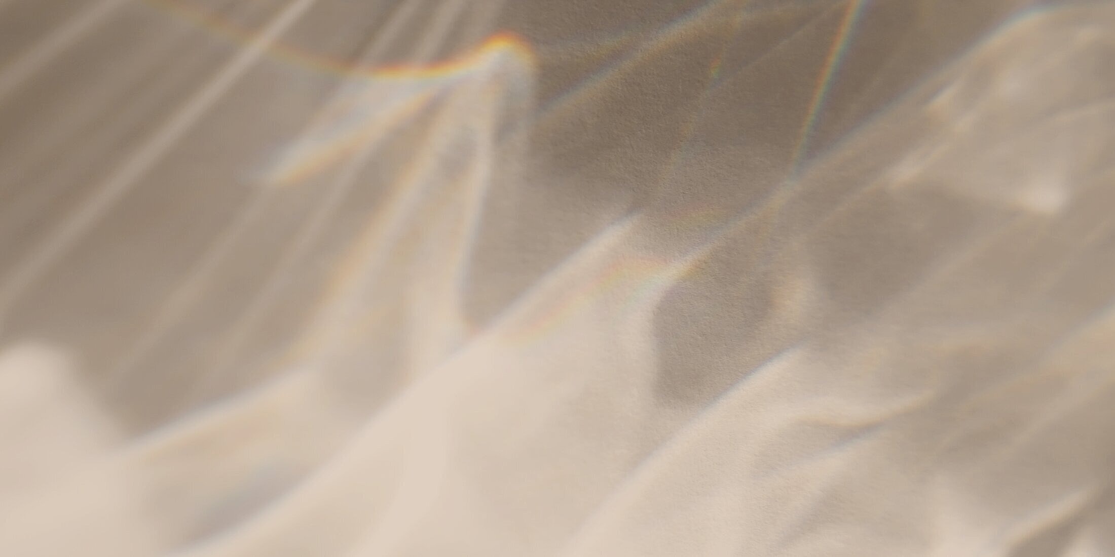 Soft, wavy fabric with light reflections.