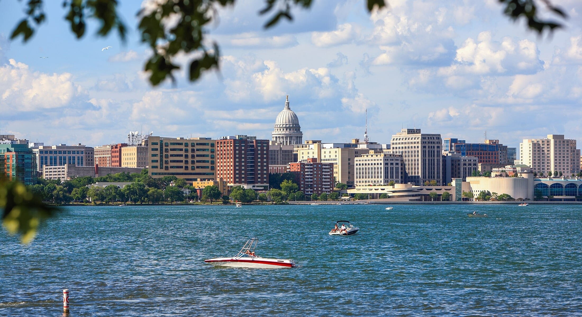 City skyline with boats on water.